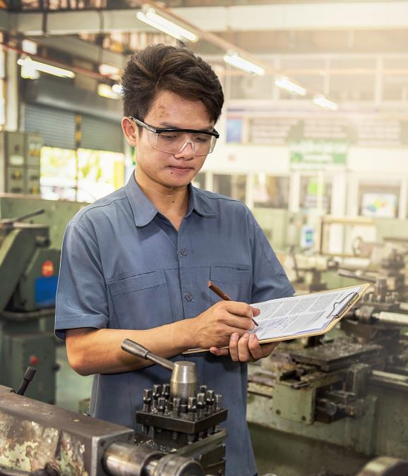 Why AssetMate, factory worker working with paper and pen